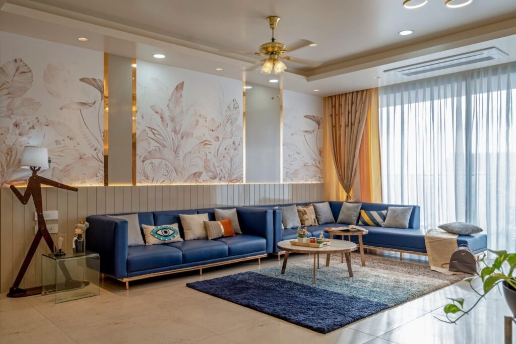 Luxury living room interior by residential interior designer in Pune with blue sofa and modern decor